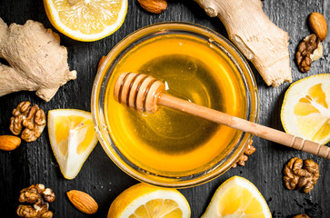 Honey background.Fresh honey with ginger and lemon.