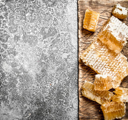 Honey background. Fresh honeycomb on the Board.