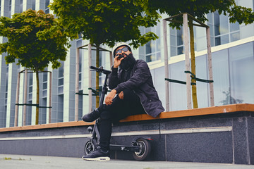 A man vaping after electric scooter.