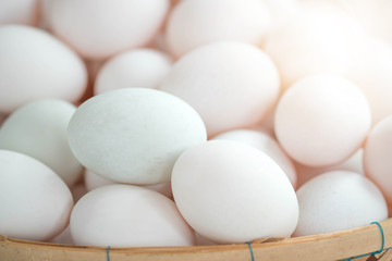 Fresh duck eggs in bamboo basket.
