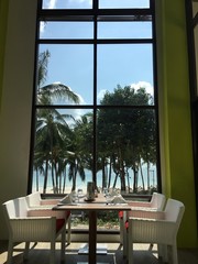 Table in front of a window with beach view