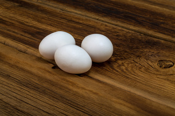 Chicken eggs on a wooden background