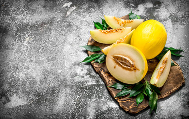 Fresh melon with green leaves.