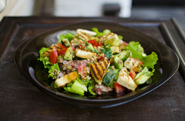 Salad with tomato, meat, cucumber, lettuce and croutons. Healthy food. Fresh food. Tasty food