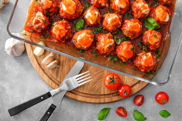 Delicious turkey meatballs in glass casserole dish on table