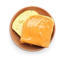 Plate with peanut butter sandwich on white background