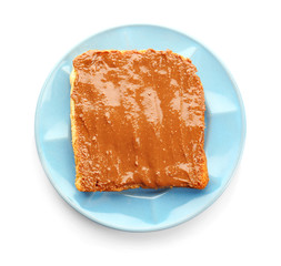 Plate with peanut butter sandwich on white background