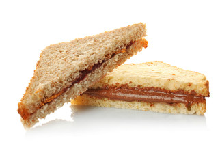 Tasty sandwiches with creamy peanut butter on white background