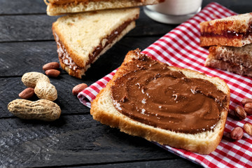 Tasty sandwich with peanut butter on table