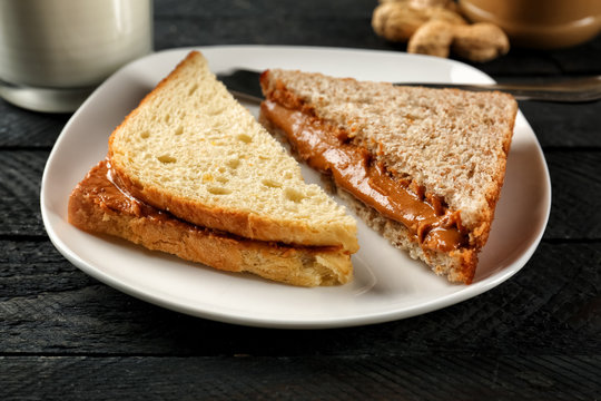 Tasty sandwiches with peanut butter on plate