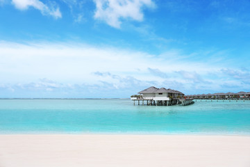 Modern beach houses on piles at tropical resort