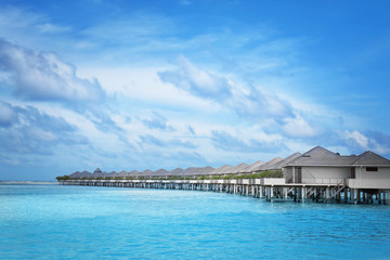 Modern beach houses on piles at tropical resort