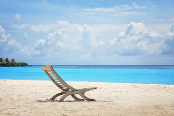 Fototapeta na wymiar Beach chair on sea shore at tropical resort