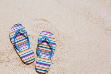 Flip-flops on beach sand. Summer vacation concept