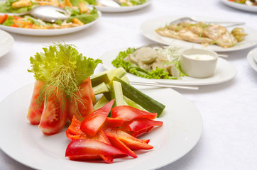 Salad with tomato, pepper and cucumber in white plate