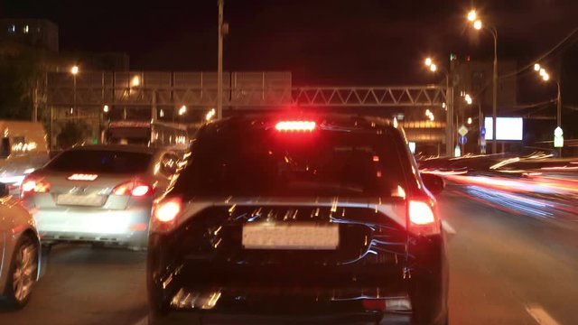 Time lapse video of car traffic on the night streets of the city. No recognizable logos, faces or trademarks.
