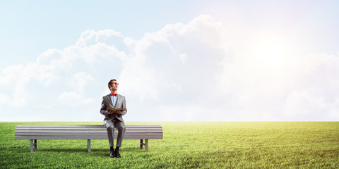 Young businessman or student studying the science in summer park