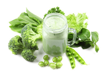 Composition with green smoothie and fresh vegetables on white background