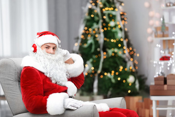 Santa Claus listening to Christmas music in living room