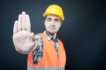 Constructor wearing equipment showing stop gesture