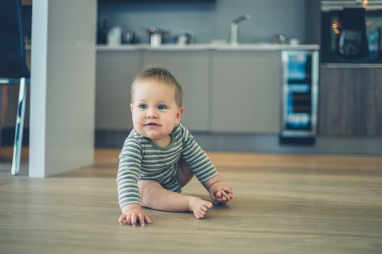 Little baby on kitchen floor