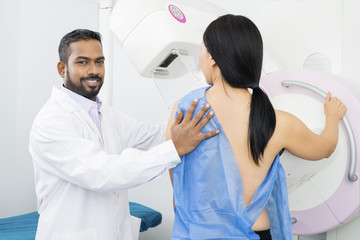Fototapeta premium Confident Doctor Assisting Woman Undergoing Mammogram Test