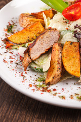 salad with fresh vegetables grilled veal and baked potatoes