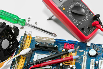 Electrical engineer checking circuit board by digital multimeter.
