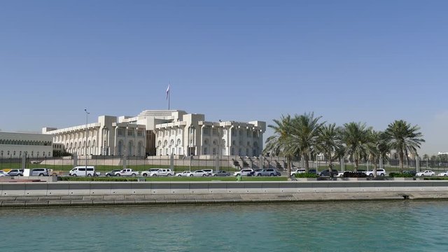 Traffic at the Corniche in Doha Qatar with the Emiri Diwan in the background