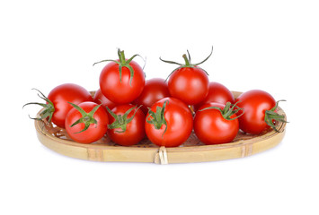 whole fresh red cherry tomato in the basket and on white background