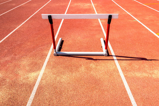 hurdle race barrier on red  running track , athletic stadium