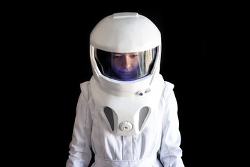 Astronaut in a helmet looks down. Fantastic space suit. Exploration of outer space.