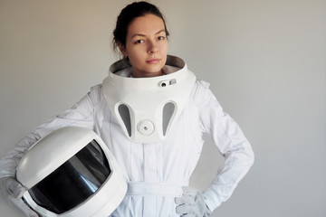 Female astronaut on a white background. Fantastic space suit. Exploration of outer space.