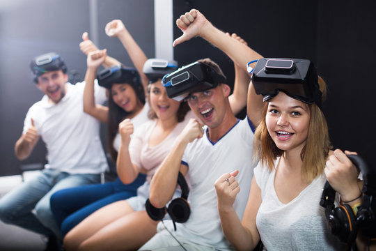  people using virtual reality glasses delighted with videogames and new tech