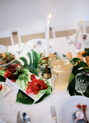 Bowl wit lemonade stands on a table with salads