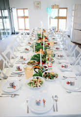 Look from above at dinner table with salads and eclairs