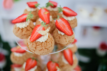 Strawberry eclairs served on transparent dish