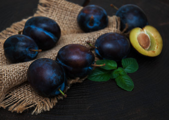 Fresh plums with green leaves