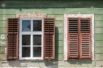 Detail of facade with old windows in rustic ancient house in Sibiu city, Romania
