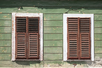 Fototapeta na wymiar Detail of facade with old windows in rustic ancient house in Sibiu city, Romania