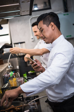 Chef preparing food in the kitchen of a restaurant  