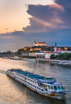 Cityscape of Bratislava, Slovakia at Sunset as Seen from a Bridge over Danube River with a Passenger Ship towards Btatislava Castle