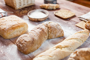 Freshly baked delicious bread on a rustic wooden table, healthy eating concept