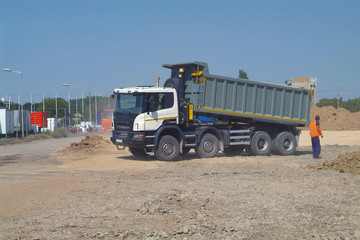 Dump truck unloading soil