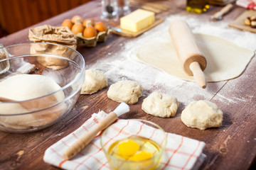 Rolled out dough on wooden table with rolling pin