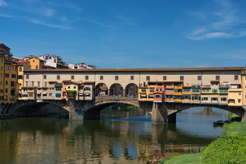 Plakat River Arno and famous bridge Ponte Vecchio (The Old Bridge) at sunny summer day. Florence, Tuscany, Italy
