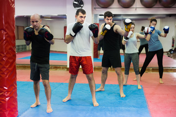 Fototapeta premium People training in gloves in the boxing hall