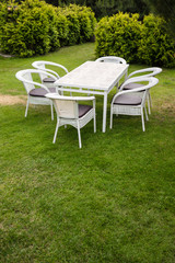 Obraz na płótnie Canvas White garden furnituse sofa armchair table on the lawn
