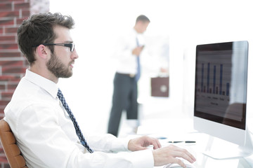 businessman working on computer with financial charts