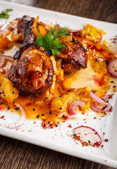 chicken legs in orange glaze sauce with chili